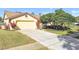 Front view of a single-story house with a two car garage at 14031 Shady Shores Dr, Tampa, FL 33613