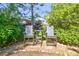 Small stone patio with two striped chairs and a small table at 14031 Shady Shores Dr, Tampa, FL 33613