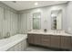 Bright bathroom with double sink vanity and a luxurious soaking tub at 145 2Nd S Ave # 616, St Petersburg, FL 33701