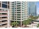 View of the multi-story building with street access, with green trees lining the sidewalks at 145 2Nd S Ave # 616, St Petersburg, FL 33701