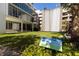 Modern building with lush green space, featuring a unique water feature and manicured landscaping at 145 2Nd S Ave # 616, St Petersburg, FL 33701