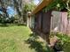 Screened porch with a wooden shelf and a partially visible yard at 14810 N 30Th St, Lutz, FL 33559