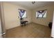 Bedroom with two windows, tiled floor, and a small chair at 14810 N 30Th St, Lutz, FL 33559