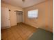 Small bedroom with closet, window, and tiled floor at 14810 N 30Th St, Lutz, FL 33559