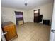 Bedroom with tile floors, window, and dresser at 14810 N 30Th St, Lutz, FL 33559