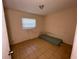 Simple bedroom with a window, and tiled floors at 14810 N 30Th St, Lutz, FL 33559