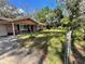 Ranch style home with a spacious front yard and trees at 14810 N 30Th St, Lutz, FL 33559