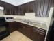 Kitchen features dark wood cabinets, granite countertops, and a double sink at 14810 N 30Th St, Lutz, FL 33559