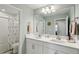 Clean bathroom with double vanity, large mirror, and shower/tub combo at 14838 Paddock Pond Ave, Lithia, FL 33547