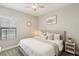 Cozy bedroom with a king-size bed and window seating at 14838 Paddock Pond Ave, Lithia, FL 33547