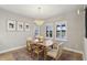 Light-filled dining area with a wood table and neutral decor at 14838 Paddock Pond Ave, Lithia, FL 33547