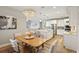 Bright dining room features a wood table and modern chandelier at 14838 Paddock Pond Ave, Lithia, FL 33547