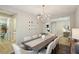 Elegant dining room with a long table and modern chandelier at 14838 Paddock Pond Ave, Lithia, FL 33547