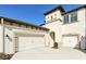 Two-car garage and front entry of charming two-story home at 14838 Paddock Pond Ave, Lithia, FL 33547