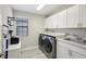 Functional laundry room with washer, dryer, and ample counter space at 14838 Paddock Pond Ave, Lithia, FL 33547