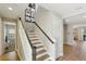 Elegant staircase with wooden accents and a light color palette at 14838 Paddock Pond Ave, Lithia, FL 33547