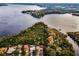 Aerial view showcasing a waterfront property with lush vegetation and neighboring houses at 1512 Big Bass Dr, Tarpon Springs, FL 34689