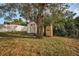 Spacious backyard with storage sheds and a large tree at 1512 Big Bass Dr, Tarpon Springs, FL 34689