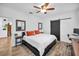 Spacious bedroom with a king-size bed, ceiling fan, and barn door at 1512 Big Bass Dr, Tarpon Springs, FL 34689