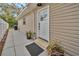 Exterior view showcasing a home's side entrance with a modern door and landscaping at 1512 Big Bass Dr, Tarpon Springs, FL 34689