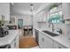 Modern kitchen with white cabinets, stainless steel appliances, and quartz countertops at 1512 Big Bass Dr, Tarpon Springs, FL 34689