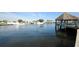 Calm waterfront with boats and a tiki hut at 1512 Big Bass Dr, Tarpon Springs, FL 34689