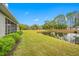 Peaceful backyard with pond view and green grass at 16130 Craigend Pl, Odessa, FL 33556