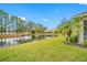 Serene backyard with pond view and lush landscaping at 16130 Craigend Pl, Odessa, FL 33556