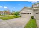 Two-car garage and manicured lawn at 16130 Craigend Pl, Odessa, FL 33556