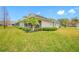 Home's back exterior showcasing a screened patio at 16130 Craigend Pl, Odessa, FL 33556