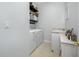 Bright laundry room with washer, dryer, and shelving at 16130 Craigend Pl, Odessa, FL 33556