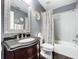 Well-lit bathroom with a decorative mirror, single sink vanity, and a shower-tub combination at 1632 Gray Bark Dr, Oldsmar, FL 34677