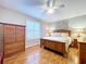 Cozy bedroom with hardwood floors, wooden furniture set, and a ceiling fan at 1632 Gray Bark Dr, Oldsmar, FL 34677