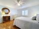 Bright bedroom with hardwood floors, a crib, and large windows at 1632 Gray Bark Dr, Oldsmar, FL 34677