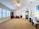 Spacious bedroom featuring plantation shutters and an ensuite bathroom entry at 1632 Gray Bark Dr, Oldsmar, FL 34677