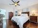 Bedroom with a large window, hardwood floors, and a dark wood furniture set at 1632 Gray Bark Dr, Oldsmar, FL 34677