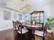 Formal dining room featuring a large table with seating for six, a chandelier and elegant decor at 1632 Gray Bark Dr, Oldsmar, FL 34677