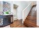 Inviting entryway featuring hardwood floors, a staircase, and a stylish console table with decorative accents at 1632 Gray Bark Dr, Oldsmar, FL 34677