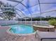 Beautiful pool and jacuzzi with a screened enclosure and paver decking at 1632 Gray Bark Dr, Oldsmar, FL 34677