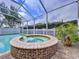 Inviting spa and pool area with screened enclosure and well-maintained patio at 1632 Gray Bark Dr, Oldsmar, FL 34677