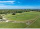 Aerial view showing large pasture perfect for horses with a curved riding track at 17120 Boy Scout Rd, Odessa, FL 33556