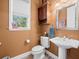 Stylish powder room with pedestal sink and wood vanity at 17120 Boy Scout Rd, Odessa, FL 33556