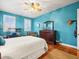 Bedroom with teal walls, hardwood floors, and ceiling fan at 17120 Boy Scout Rd, Odessa, FL 33556