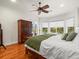 Bright bedroom with hardwood floors, a king-size bed, and access to a patio at 17120 Boy Scout Rd, Odessa, FL 33556