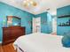 Bedroom with teal walls and hardwood floors at 17120 Boy Scout Rd, Odessa, FL 33556