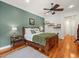 Main bedroom with hardwood floors, king bed, and green accent wall at 17120 Boy Scout Rd, Odessa, FL 33556