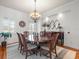 Formal dining room with octagonal table, chandelier, and hardwood floors at 17120 Boy Scout Rd, Odessa, FL 33556