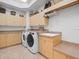 Bright laundry room with ample cabinet and counter space at 17120 Boy Scout Rd, Odessa, FL 33556