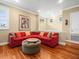 Relaxing living room featuring a red sectional sofa and hardwood floors at 17120 Boy Scout Rd, Odessa, FL 33556