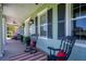 Relaxing covered porch with rocking chairs and red accents at 17120 Boy Scout Rd, Odessa, FL 33556